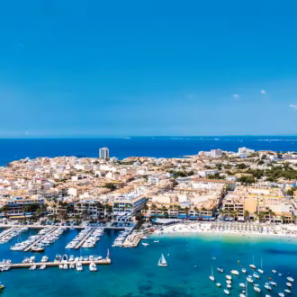Aerial view of Colònia de Sant Jordi with turquoise waters and sandy beaches