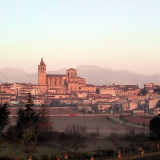 Stone buildings and church tower in the historic center of Sineu, Mallorca.