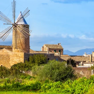 Traditional stone houses and windmill in the quiet town of Algaida, Mallorca.
