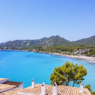 View of Canyamel Beach with turquoise waters and surrounding hills in northeast Mallorca