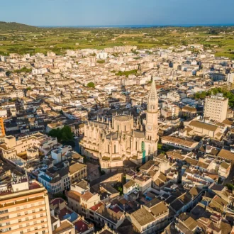 Manacor town centre with church tower and weekly market stalls