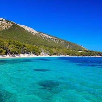 Cala Pi cove in Mallorca with turquoise water and cliffs.