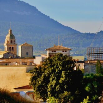 Historic town with windmill and mountains