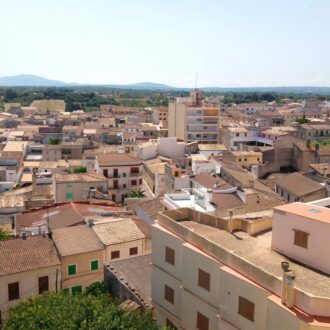 Aerial view of Santa Margalida town with church tower and countryside.