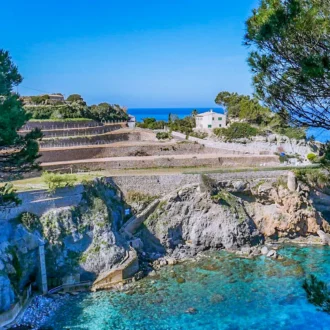 Stone bathing platforms and turquoise water at Cala Banyalbufar on Mallorca’s west coast.