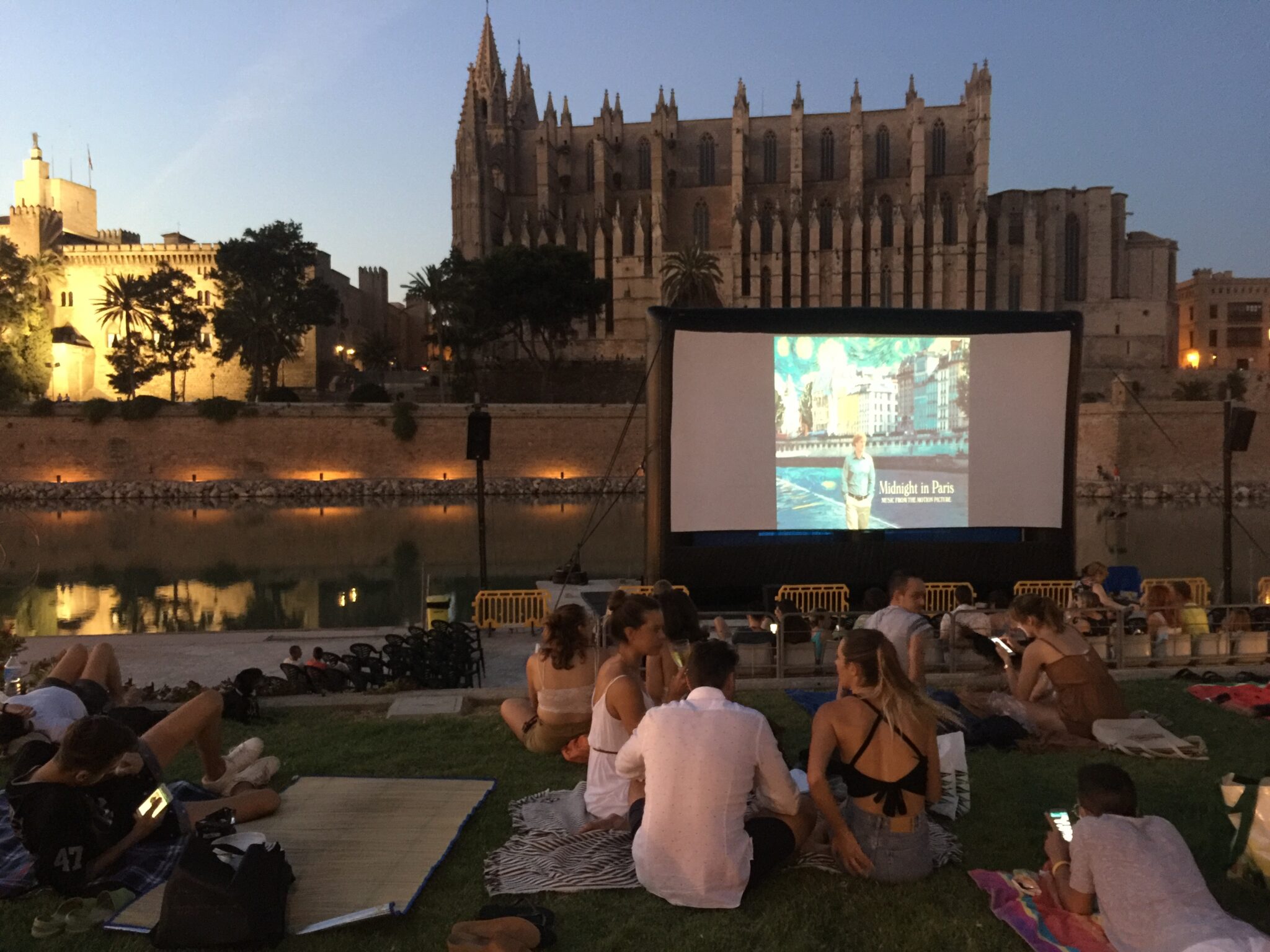 Parc de la Mar lake with people watch outdoor cinema