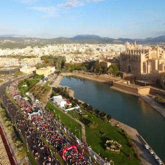 Runners passing Palma Cathedral during Palma Marathon Mallorca